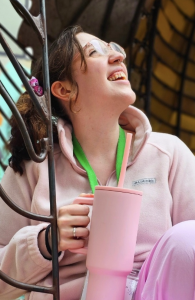 A woman smiles while looking upwards. 